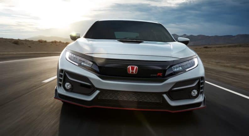 A white 2020 Honda Civic Type R is shown from the front on a race track.