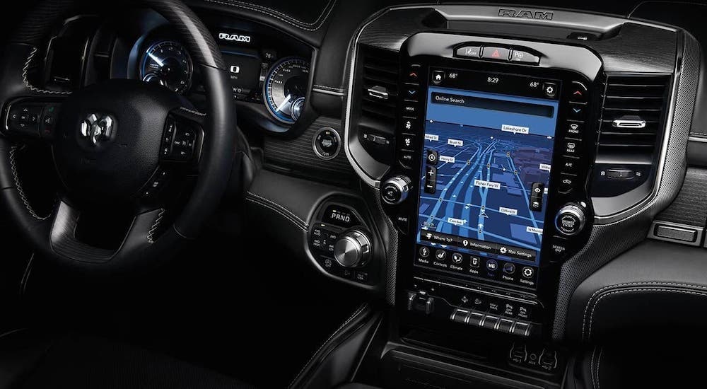 The large touchscreen and black dashboard are shown in a 2020 Ram 1500, winner of the 2020 Ram 1500 (new Ram) vs 2020 Toyota Tundra comparison.