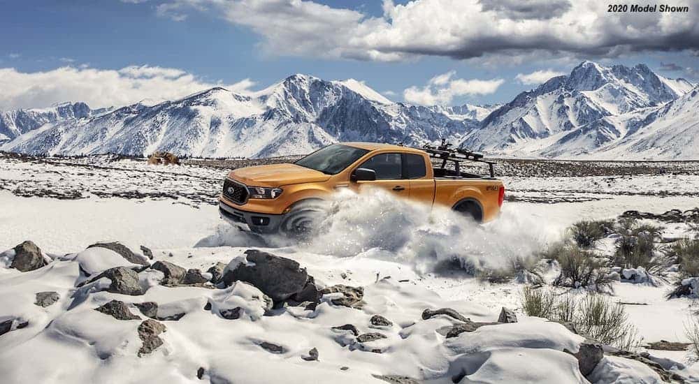 Ford rumors are saying the Ranger will be redesigned in 2022, here's a gold 2020 Ford Ranger driving through the snow.