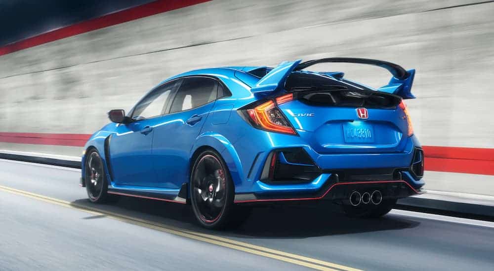 A blue 2020 Honda Civic Type-R is driving in a tunnel after leaving a Honda dealer.