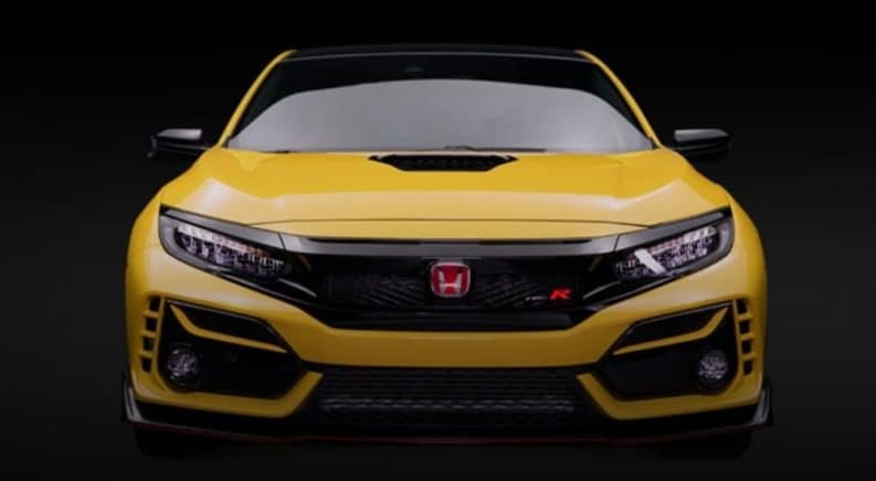 The front of a yellow 2021 Honda Civic Type R Limited is shown on a dark background.