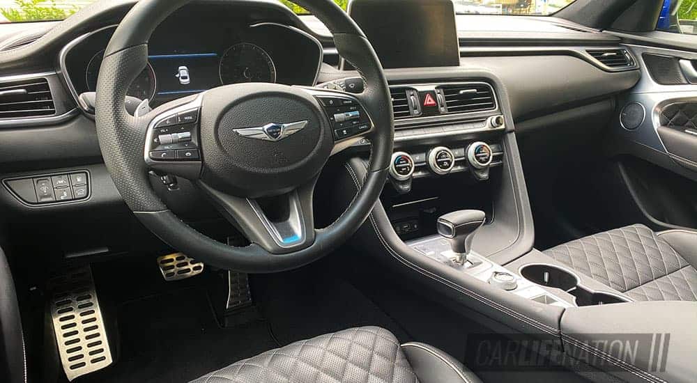 The black and grey interior of a 2020 Genesis G70 is shown.