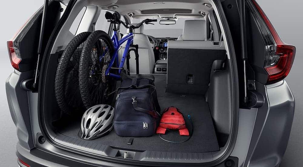 The cargo area of a 2020 Honda CR-V is shown filled with bikes and luggage after winning the 2020 Honda CR-V vs 2020 Mazda CX-5 comparison.