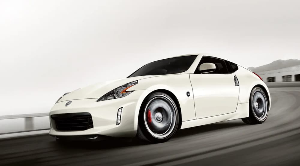 A white 2020 Nissan 370Z is driving on a winding road.