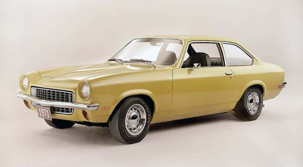 A yellow 1971 Chevy Vega is parked on a white background.