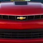 A closeup shows the grille and Chevrolet logo on a red 2014 Chevy Camaro SS from a local Chevy dealership.