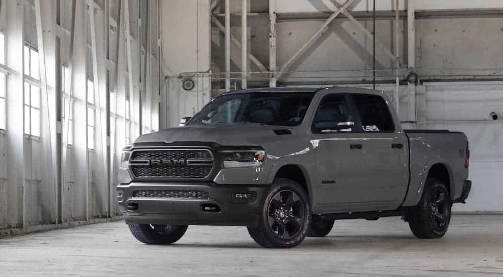 A grey 2020 Ram 1500 Built to Serve Edition is parked in a white warehouse.