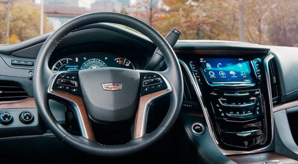The dashboard and steering wheel are shown on the interior of a 2020 Cadillac Escalade, the winner of the 2020 Cadillac Escalade vs 2020 Chevy Suburban comparison.