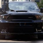 A black 2020 Dodge Durango SRT is shown from the front on a city street.