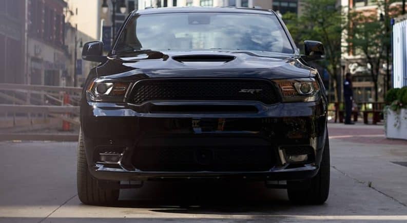 A black 2020 Dodge Durango SRT is shown from the front on a city street.