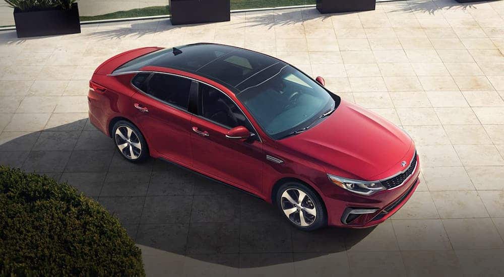 A red 2020 Kia Optima is shown from a high angle after losing the 2020 Ford Fusion vs 2020 Kia Optima comparison.