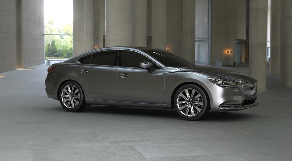 A gray 2020 Mazda 6 is parked under a concrete structure.