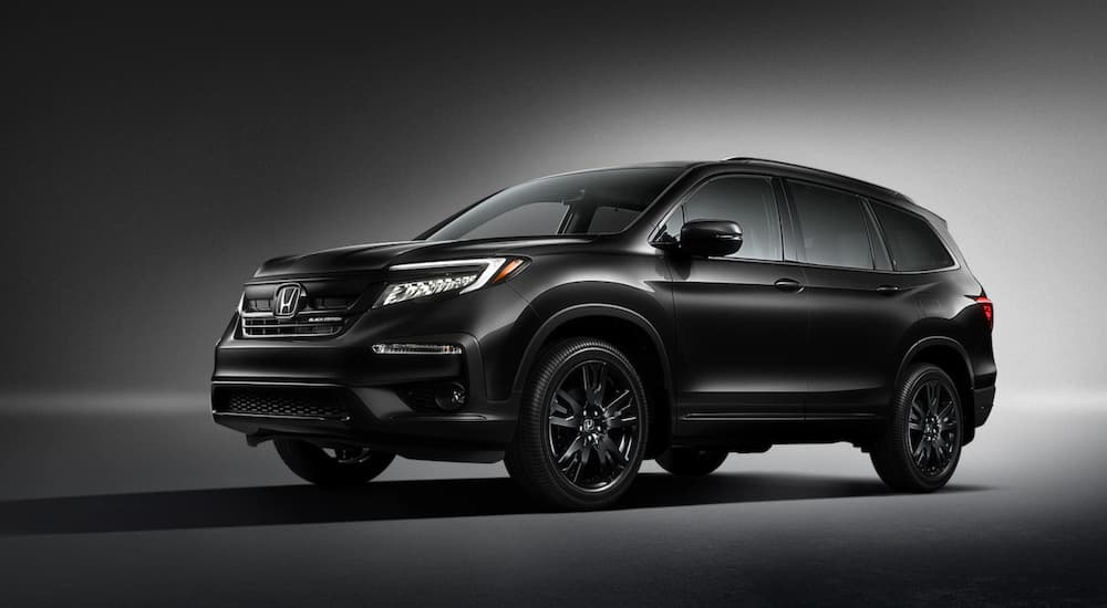 A Black Edition 2020 Honda Pilot is shown on a dark background.