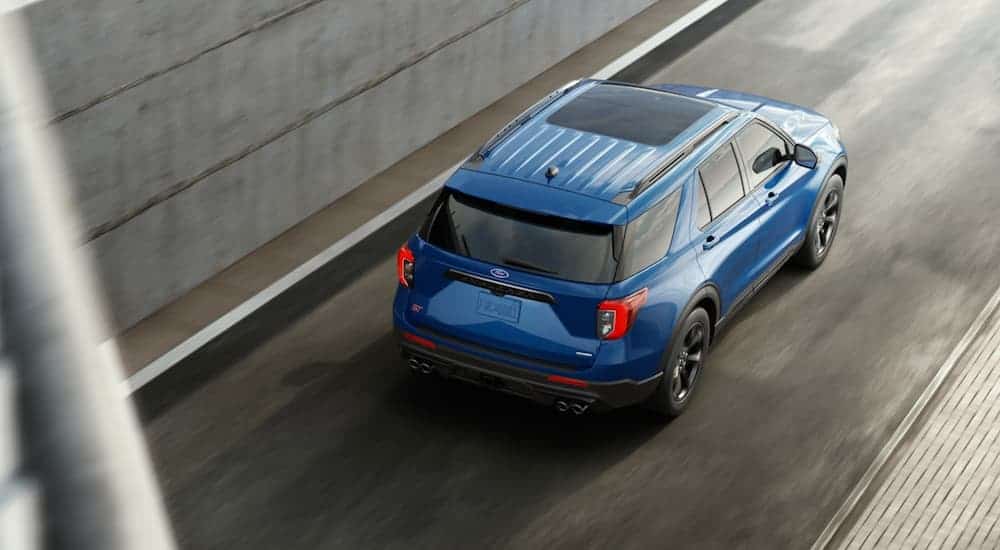 A blue 2020 Ford Explorer is shown from an above angle coming out of a highway tunnel after leaving a new car dealership near me.