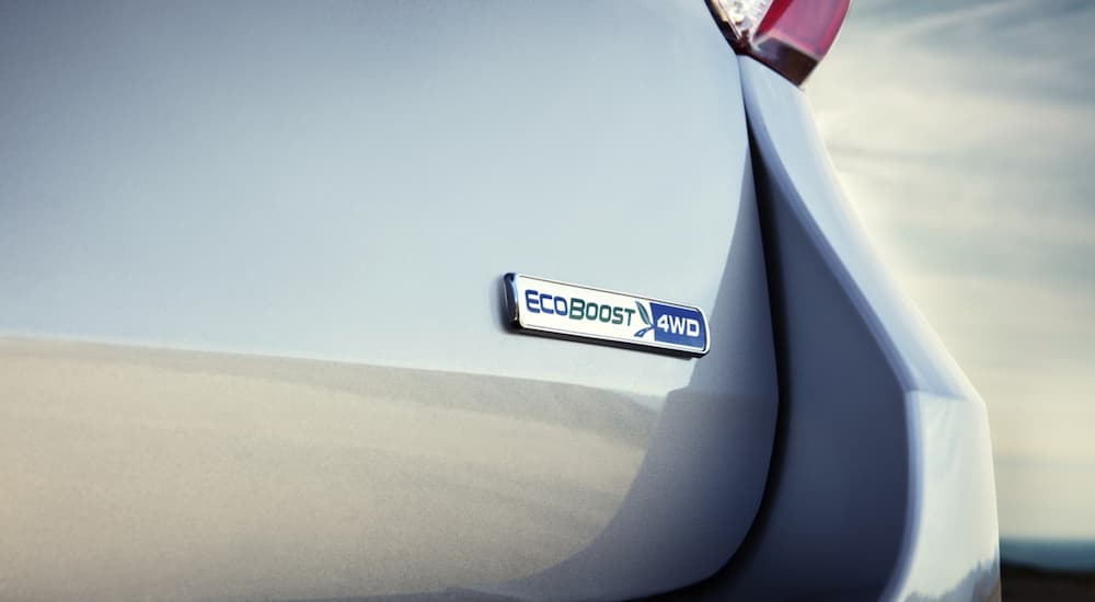 The EcoBoost badge is shown on the back of a silver 2020 Ford Explorer.