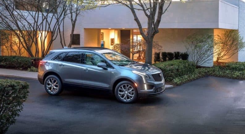 A silver 2020 Cadillac XT5 is shown parked in a driveway after winning the 2020 Cadillac XT5 vs 2020 Audi Q5 competition.