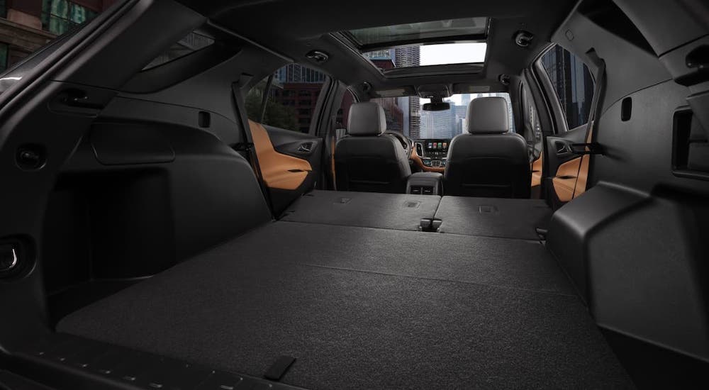 The rear seats are shown folded down from the cargo area in a 2020 Chevy Equinox.