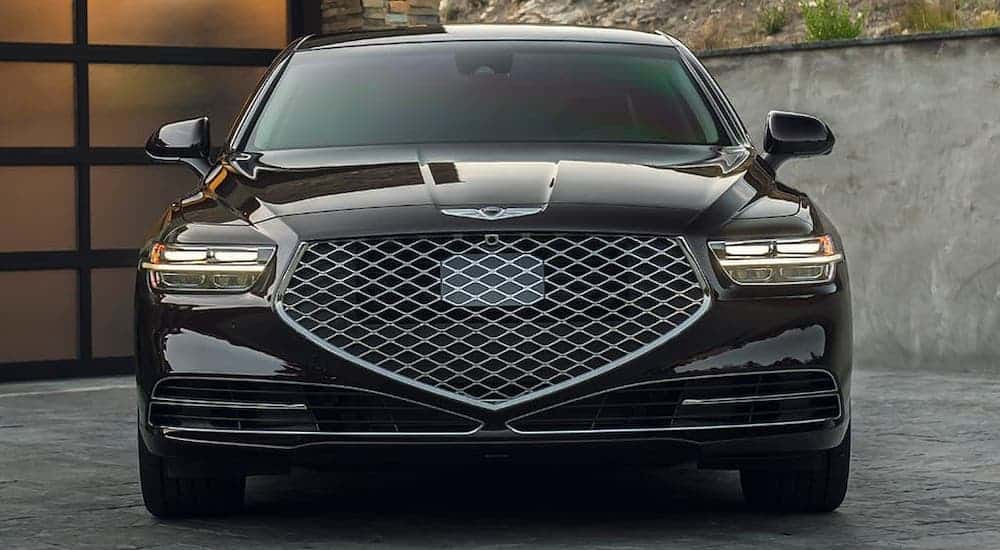 A black 2020 Genesis G90 is parked in a driveway and shown from the front.
