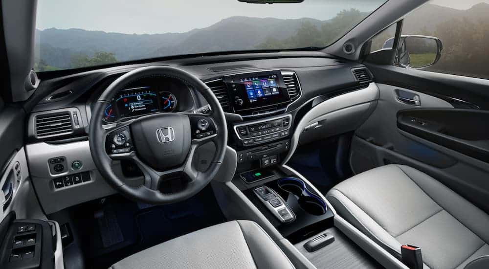 The black and grey interior of a 2021 Honda Pilot is shown.