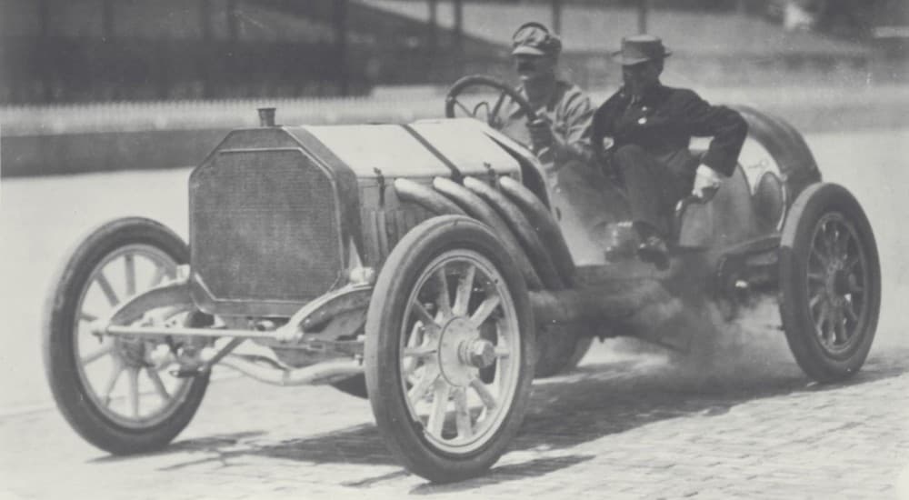 Louis Chevrolet is racing a car in 1910, shown in black and white.