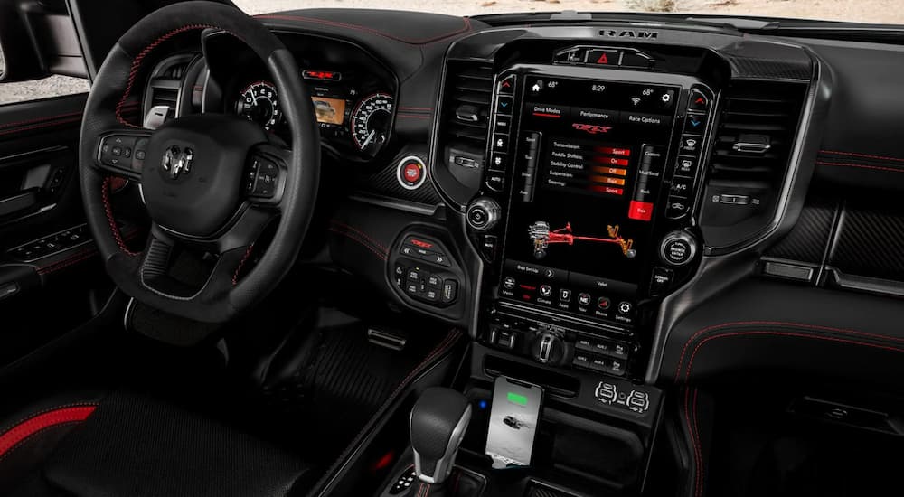 The dashboard and infotainment features in a 2021 Ram TRX are shown.