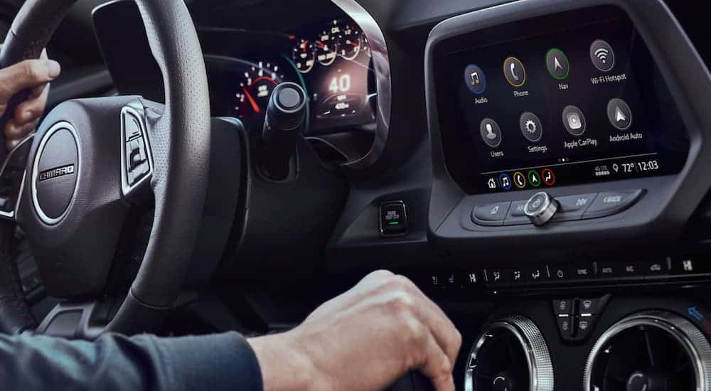 A closeup of the dashboard and touchscreen is shown in a 2021 Chevy Camaro.