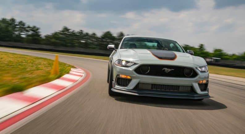 A grey 2021 Ford Mustang Mach 1 is racing around a track.