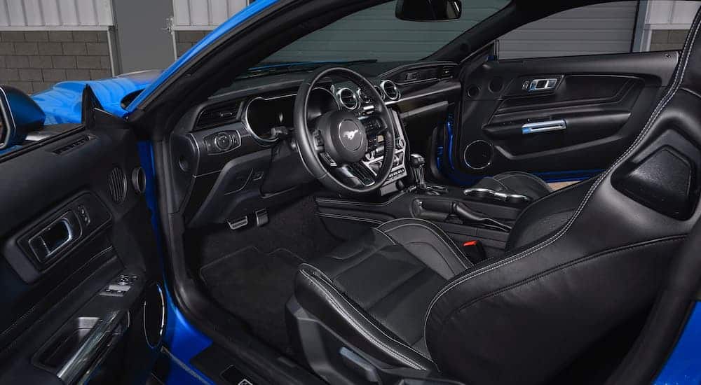 The interior of a blue 2021 Ford Mustang Mach 1 is shown through an open door.