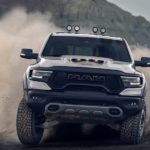 A silver 2021 Ram 1500 TRX is kicking up dust while off-roading.