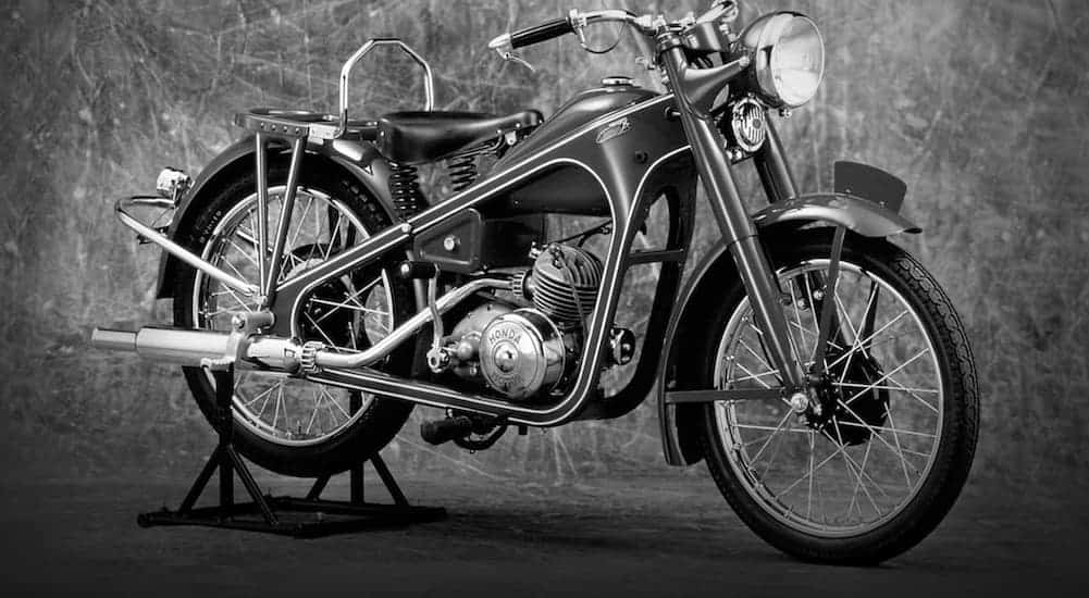 A 1940s Honda motorcycle is shown in black and white.