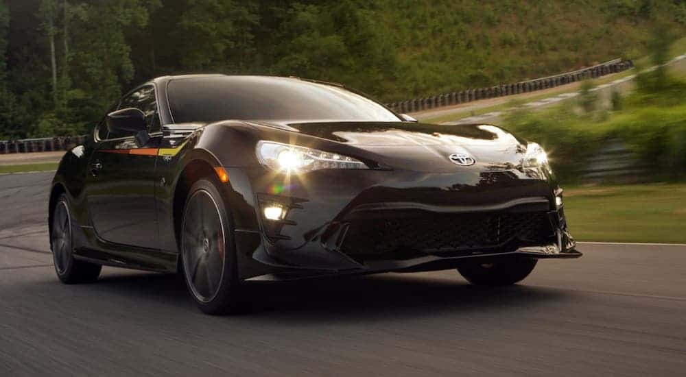 A black 2019 Toyota 86 is driving on a racetrack.