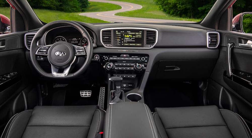 The black interior is shown a 2021 Kia Sportage from the backseat.