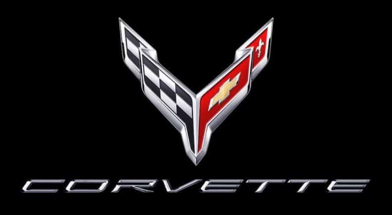 The Chevy Corvette dual racing flag emblem is shown on a black background.
