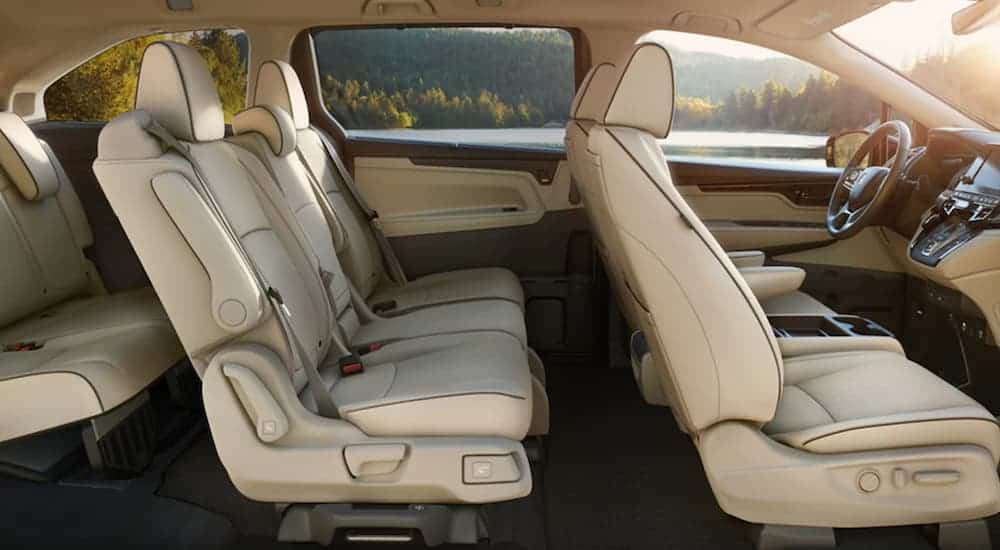 The tan interior of a 2021 Honda Odyssey is shown from the side.