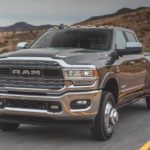 A black 2020 Ram 3500 Limited is driving down a desert highway.
