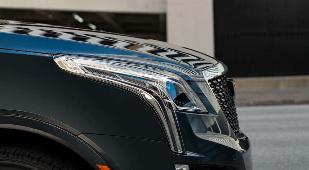 A close up is shown of the headlight on a grey 2021 Cadillac XT5.