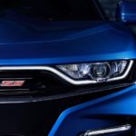 A closeup shows the grille and badging on a blue 2021 Chevy Camaro SS.