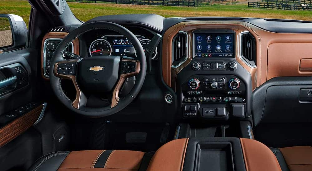 The black and brown interior is shown from the backseat on a 2021 Chevy Silverado 1500.