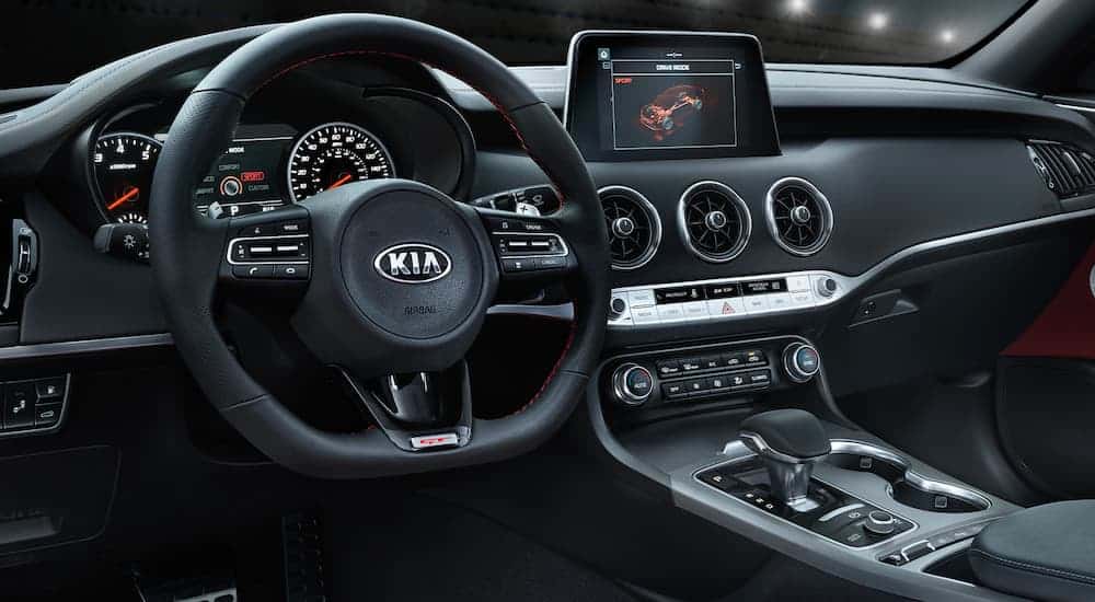 The black and silver interior is shown on the 2021 Kia Stinger from the drivers side.