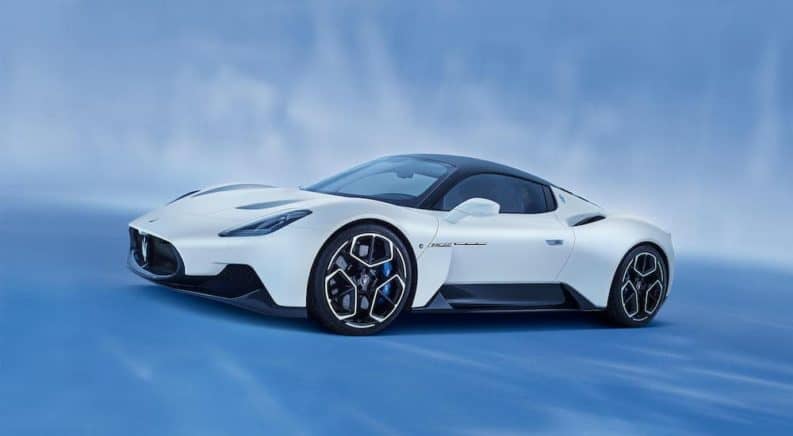 A white 2021 Maserati MC20 is shown against a blue background.