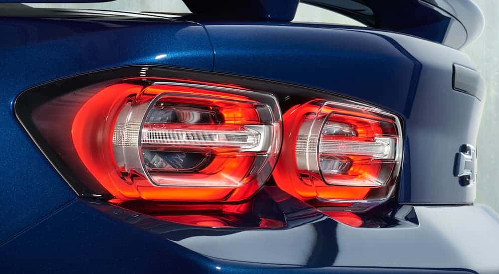A close up is shown of the illuminated tail light on a blue 2021 Chevy Camaro 2SS coupe.
