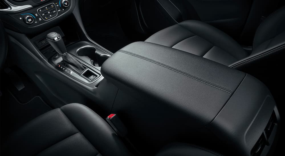 A close up is shown of the black center console and seats in a 2021 Chevy Equinox.