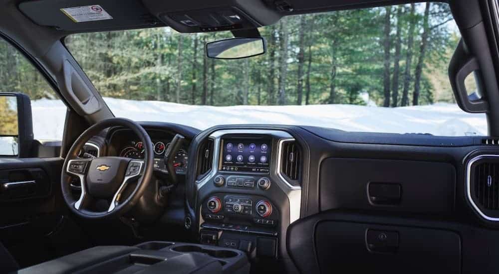 The black interior and infotainment system is shown on a 2021 Chevrolet Silverado 3500HD.