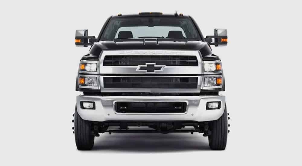 A black 2021 Chevy Silverado 4500 is shown from the front against a gray background.