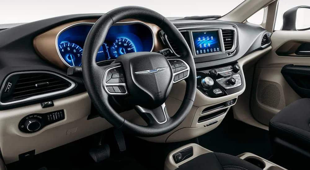 The wheel and dashboard are shown in a 2021 Chrysler Voyager.