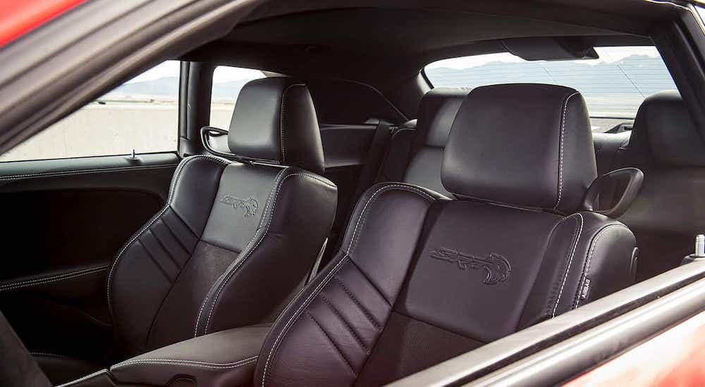 The black interior is shown through the driver side window on a 2021 Dodge Challenger SRT Super Stock.