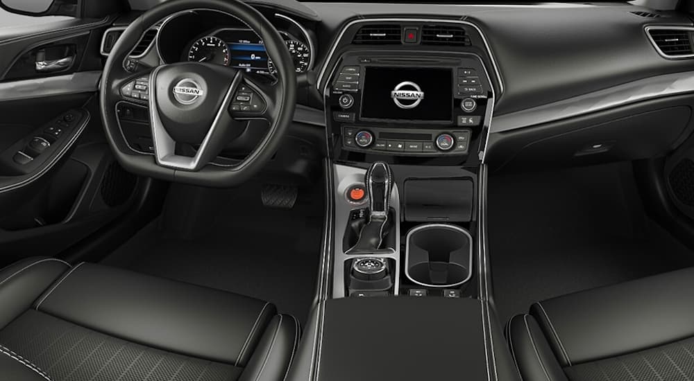 The front black interior is shown from the rear seats on a 2021 Nissan Maxima.