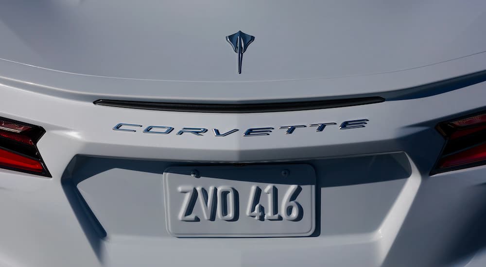 A close up is shown of the rear badging and emblem on a white 2021 Chevy Corvette.