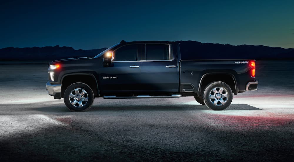A black 2021 Chevy Silverado HD is shown from the side in the desert.