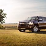 A burgundy 2018 Chevy Silverado 1500, a popular used truck in Atlanta, is parked in a field.